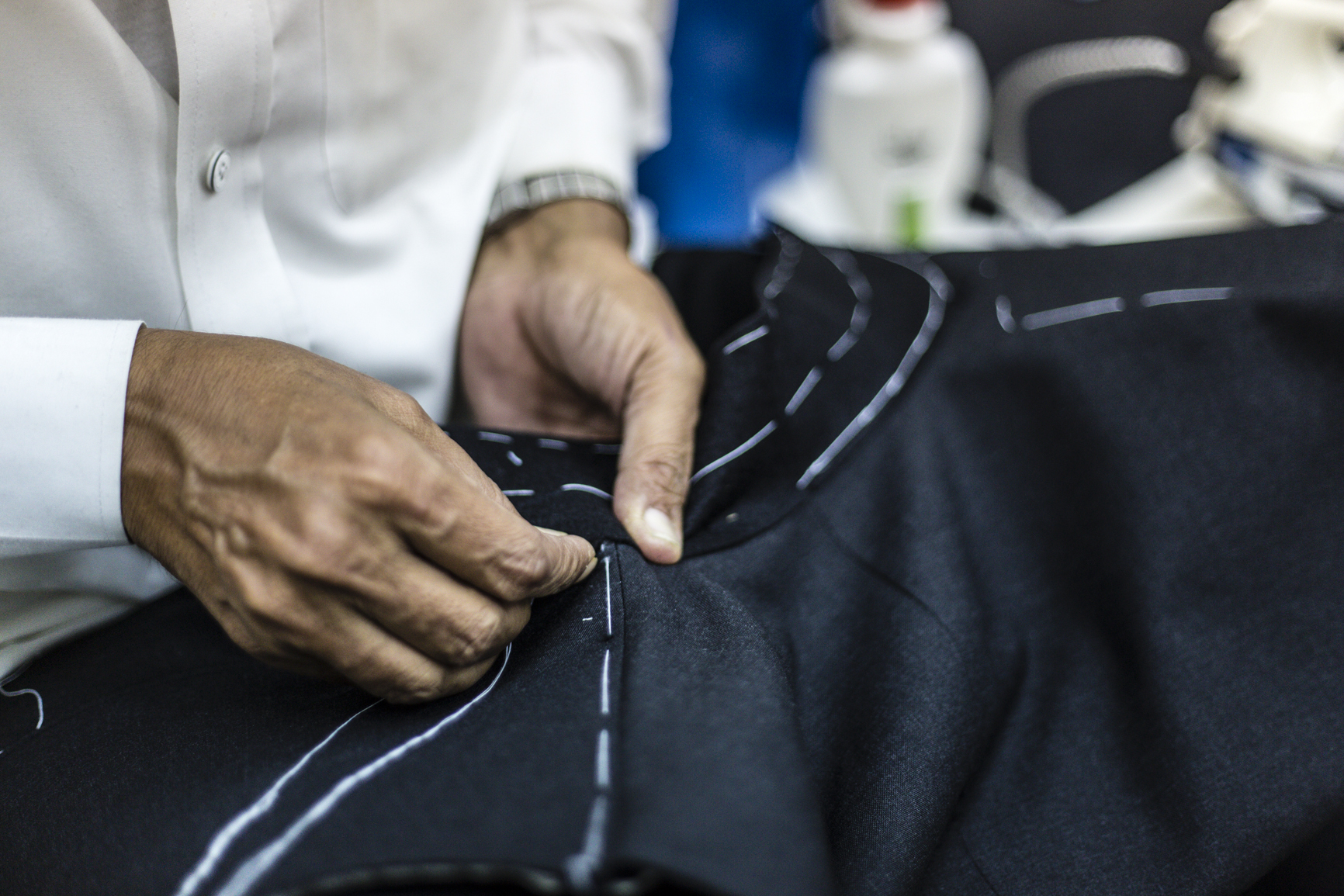 Master tailor hand-basting a bespoke garment